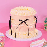 Vintage Cake - Single Colour with hand-piped Swiss Meringue icing, black ribbon detail, and six layers of sponge by Crumbs & Doilies